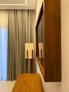 a room with a mirror and a wooden table at Oceana Trinco in Trincomalee