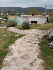 a stone path in front of a building at Cerro de sol in Salsipuedes