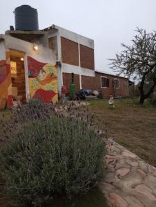 a building with a painting on the side of it at Cerro de sol in Salsipuedes