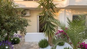 a garden with plants and flowers in front of a building at Kineta Prime Suites No8 in Kineta