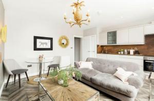a living room with a couch and a table at Scandi Lux retreat in Stockholm