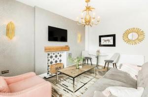 a living room with a couch and a table at Scandi Lux retreat in Stockholm