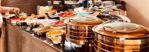 a kitchen with many pots and pans on a counter at Ram Anandam inn in Ayodhya
