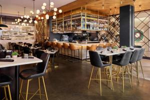 a restaurant with tables and chairs and a bar at Arlo Chicago in Chicago