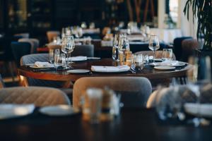 a restaurant with tables and chairs with wine glasses at Skyline Hotel Detroit Airport, SureStay Collection by Best Western in Romulus