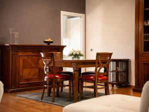a dining room table with chairs and a mirror at Villa Domus Roma in Rome