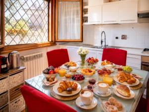 a table with a breakfast of croissants and fruit at Villa Domus Roma in Rome +43 photos