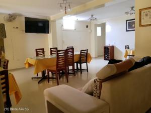 a living room with a couch and a table and chairs at Hotel Graxiomy in Sechura