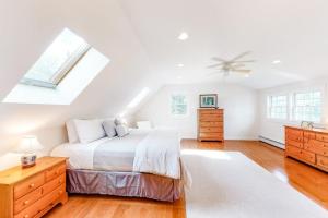 a white bedroom with a bed and a skylight at Dog-friendly, bayfront home w/rocky beach, full kitchen, washer/dryer & firepit in Gouldsboro