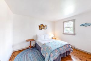 a bedroom with a bed and a window at Dog-friendly, bayfront home w/rocky beach, full kitchen, washer/dryer & firepit in Gouldsboro
