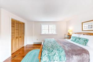 a bedroom with a large bed and a window at Dog-friendly, bayfront home w/rocky beach, full kitchen, washer/dryer & firepit in Gouldsboro