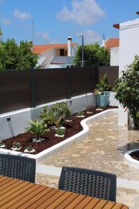 a patio with a fence and a garden at Casa Crisel in Aljezur