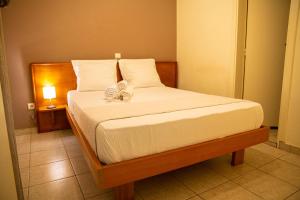 a bedroom with a bed with a flower on it at Direl Lodge in Libreville