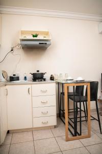 a kitchen with a counter and a table and a stove at Direl Lodge in Libreville