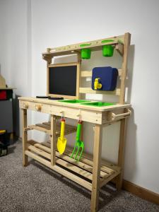 a wooden desk with a computer and tools on it at Apartments SKY Kopaonik in Kopaonik