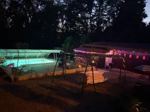 a swimming pool in a yard at night at Studio en campagne Chez Maga in Foëcy
