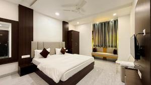 a bedroom with a bed and a television in it at Hotel Shree Banke Bihari Heritage in Maheshwar