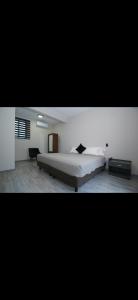 a bedroom with a large bed in a room at Lailinn Serenity in Santa Cruz Xoxocotlán