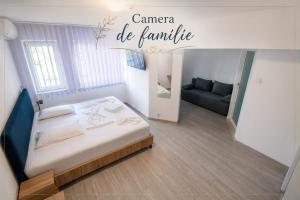 a small room with a bed and a couch at Hotel Proton in Neptun