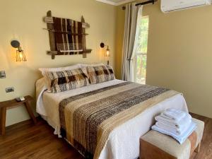 a bedroom with a large bed and a window at Hostal Lago Ranco Boutique in Lago Ranco