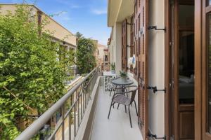 a balcony with a table and chairs and plants at Asikiko Suites in Rethymno