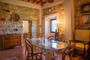a dining room with a glass table and chairs at Fattoria Il Milione Agriturismo in Florence