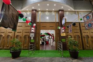 an entrance to a wedding ceremony with balloons and plants at Sama Al Bayt in Mecca