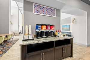 a bar with bottles of wine on a counter at Hampton Inn & Suites By Hilton Knightdale Raleigh in Raleigh