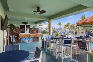 a patio with blue and white chairs and tables at Hollywood Beach Tower in Hollywood +23 photos