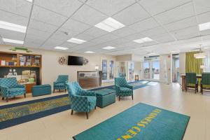 a waiting room at a hospital with chairs and a tv at Hollywood Beach Tower in Hollywood