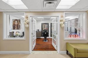 a hallway with a hair salon with flowers on the walls at Hollywood Beach Tower in Hollywood