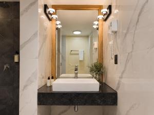 a bathroom with a white sink and a mirror at Terraza & Loft San Ángel in Mexico City +134 photos