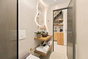 a bathroom with a sink and a mirror at Asikiko Suites in Rethymno +40 photos