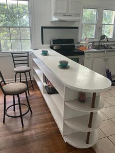 a kitchen with a white counter and two chairs at Bankston House B&C in Marietta