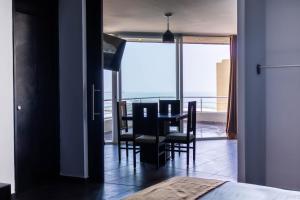 a dining room with a table and chairs and a balcony at Hotel Costa Verde in Veracruz