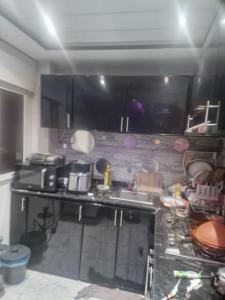 a kitchen with a sink and a counter top at apparemment wifaq in Temara +5 photos