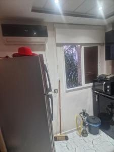 a kitchen with a refrigerator and a window at apparemment wifaq in Temara
