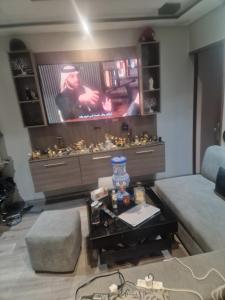 a living room with a couch and a table at apparemment wifaq in Temara