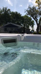 a television in a swimming pool in a house at Chalet met grote tuin en privé jacuzzi in Wijdenes