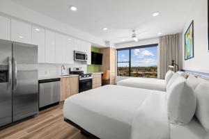 a hotel room with two beds and a kitchen at The 233 Suites Unscripted By Hyatt in Mesa