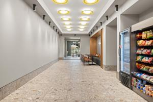 an empty corridor of a store with a long aisle at The 233 Suites Unscripted By Hyatt in Mesa