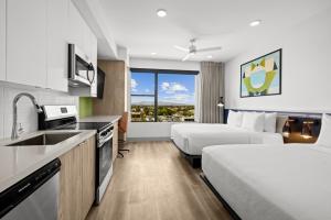 a hotel room with two beds and a kitchen at The 233 Suites Unscripted By Hyatt in Mesa