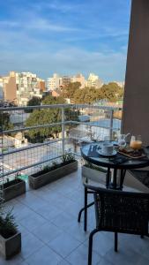 a balcony with a table and a view of a city at Monoambiente Céntrico único in Puerto Madryn
