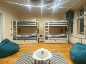 a room with three bunk beds and a table at FG Boutique Hostel in Sarajevo +8 photos