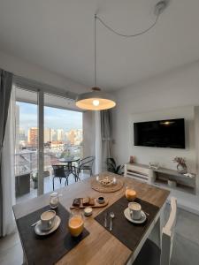 a dining room with a table and a large window at Monoambiente Céntrico único in Puerto Madryn