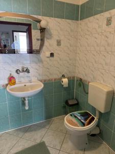 a bathroom with a toilet and a sink at Dom Wypoczynkowy U Kasi in Jurgów +38 photos