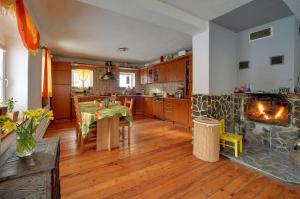 a kitchen with a table and a fireplace at Biotanika in Michałkowa