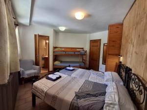 a small bedroom with a bed and a chair at Setcases-Vallter hostal Mitja Pensió 3 in Setcases