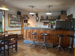 a bar in a restaurant with a table and stools at Setcases-Vallter hostal Mitja Pensió 3 in Setcases +16 photos