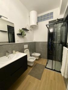 a bathroom with a toilet and a sink and a shower at Perla Blu House in La Spezia +29 photos